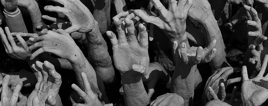 Buddhist sculpture 'Hands from Hell', from the Watrongkhun White Temple, Thailand.