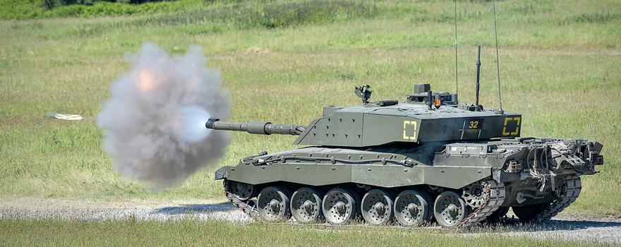 A Challenger 2 tank on Castlemartin Ranges in Pembrokeshire, Wales, fires a 'Squash-Head' practice round [UK MoD].